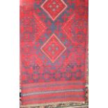 An Mershwari wool runner with lozenge centre in a red and blue colourway 250cm x 56cm
