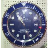 A Rolex wall clock, the dial in the form of the Oyster Perpetual Date Submariner in a blue