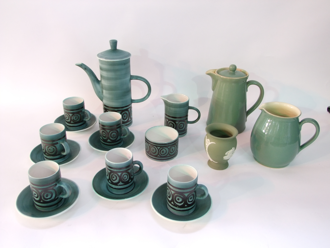 A Rye pottery coffee set with black painted concentric circle and line decoration on a dark jade