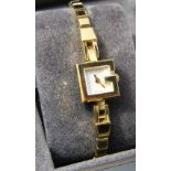 A Gucci ladies wristwatch and strap with gilt finish with original box and purchase document, August