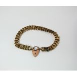 A gold link bracelet with a 9ct gold padlock clasp, 47gm