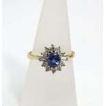 An 18ct gold ring set with a total of twelve diamonds and central sapphire