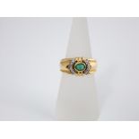 An 18ct emerald and diamond set ring, the central stone encompassed by two bands of diamonds, size