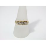 An 18ct gold and five stone diamond ring, size T