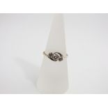 An 18ct gold and platinum three stone diamond ring, size N
