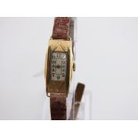 An Art Deco ladies wrist watch with rectangular dial and 18k casework with 15 jewel movement,