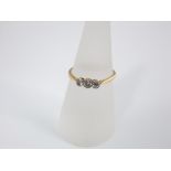 An 18ct gold and platinum set three stone diamond ring, circa 1920, size O