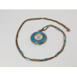 A Jean Perret of Geneva pendant watch set in a pale blue enamel and gilt framework the chain with