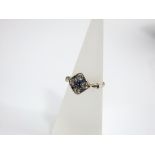 An 18ct gold Art Deco ring set with four diamonds and sapphire cross