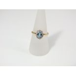 An 18ct gold aquamarine and diamond cluster ring, size R