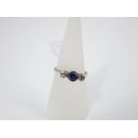 An 18ct sapphire and diamond three stone diamond ring, size O