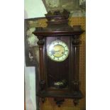 A late 19th century wall clock with walnut case, with applied detail with 8 day striking movement (