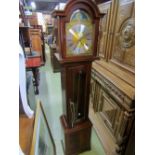 A contemporary reproduction grandmother clock, the mahogany case with arched hood enclosing a