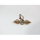 A 9ct gold bar brooch Art Nouveau in style set with a central turquoise stone