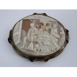A 19th century cameo brooch, the oval panel unusually showing an industrious bake house in a