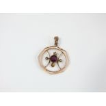 An Edwardian 9ct gold pendant of octagonal form, set with a central amethyst and four seed pearls in