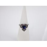 A 14ct white gold diamond and tanzanite set ring of triangular form, size L