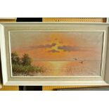 A 20th century oil painting on canvas of a lake scene at sunset with a pair of wildfowl in flight