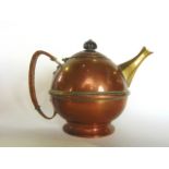 An arts and crafts copper tea pot, the body of globular form, with wicker handle and short