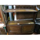 A late Victorian oak hanging wall cabinet, partially enclosed by a pair of rectangular panelled