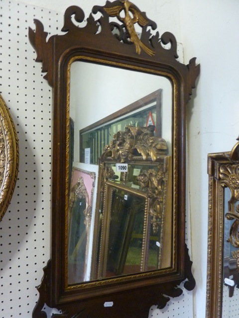 A Georgian style wall mirror, the partially moulded frame with gilt slip, fretwork surround and