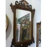 A Georgian style wall mirror, the partially moulded frame with gilt slip, fretwork surround and