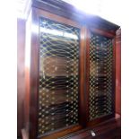 A Georgian mahogany bureau bookcase, the bureau of four long graduated drawers, the fall flap with