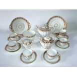 A collection of Victorian tea wares of fluted form with painted and gilded leaf border decoration