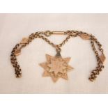 A 9ct gold Victorian star pendant with engraved decoration and integral unmarked yellow metal chain,