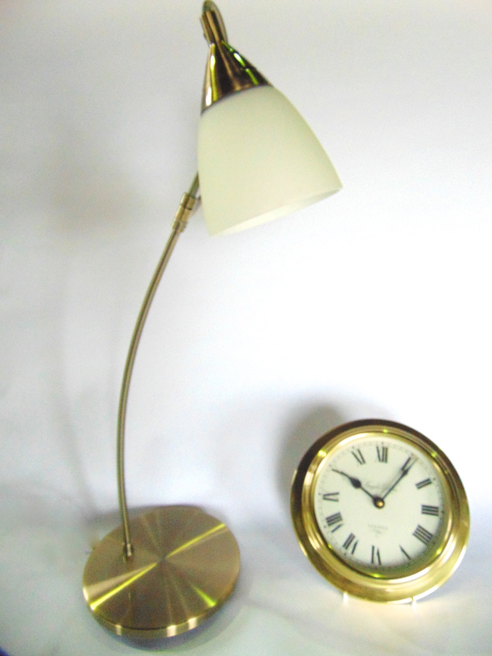 A brass cased marine or bulk head dial clock with quartz movement, further vintage table lamp