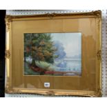 A pair of early 20th century watercolours by O J Bevis, one showing a lake scene with trees, the