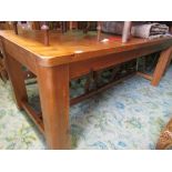 A stripped pine kitchen table of rectangular form with rounded corners raised on four heavy square