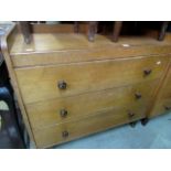 A Gordon Russell oak bedroom suite comprising chest of three drawers, bedside cupboard enclosed by a