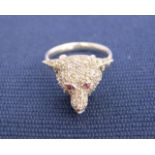 A platinum diamond, ruby and enamel fox head ring, set with single cut diamond and ruby cabachon