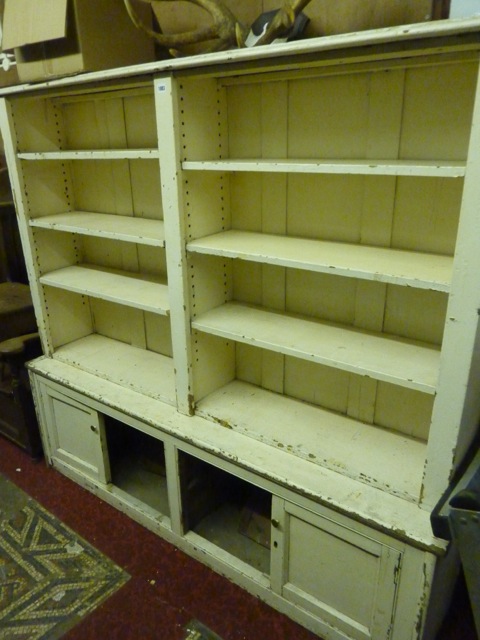 A 19th century painted pine two sectional bookcase, the upper two divisional section with adjustable