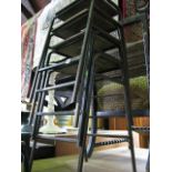 A stack of four steel framed ex school/laboratory stools with rectangular ply wood seats, central