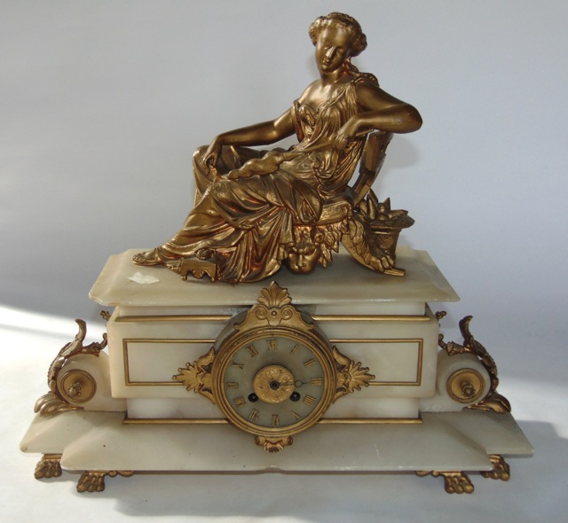 A mid 19th century onyx and gilded brass mantle clock in the classical style, the eight day striking