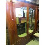 A good quality Edwardian inlaid mahogany wardrobe, the two central doors with bevelled edge mirror