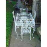 A cream painted steel framed garden table of rectangular form with plate glass top and scrollwork