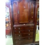 An Edwardian mahogany compatum wardrobe the central column fitted with five long graduated and three