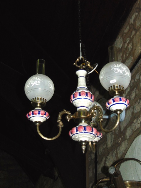 A ceramic and brass three branch ceiling light in the Victorian style with etched glass shades