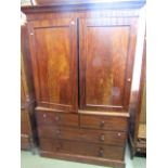 A Victorian mahogany linen press of two long and two short drawers, the upper section enclosed by