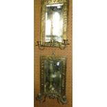 A pair of Victorian embossed brass wall sconces with bevelled edge mirrored plates, each