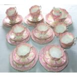 A collection of late 19th century Athens pattern tea wares of fluted form with pink printed border