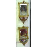 A pair of small 19th century gilded wall brackets, each enclosing a bevelled edged mirror plate,
