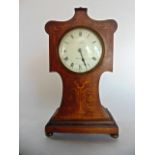 An art nouveau mahogany mantle clock with geometric marquetry inlaid detail, convex dial and eight