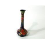 A Moorcroft Pomegranate pattern vase with globular body and slender drawn neck, impressed marks to