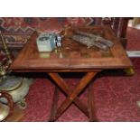 A folding hardwood games table inlaid with brass, an Eastern knife and fork set and a vintage