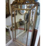 A contemporary reproduction wall mirror of rectangular form, the gilt moulded frame with C scroll,