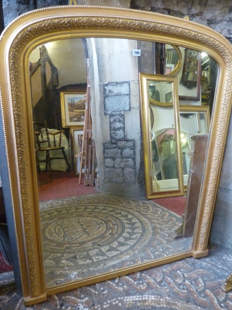 A Victorian style over mantle mirror with stepped arched and moulded gilt frame, 121 cm high x 102